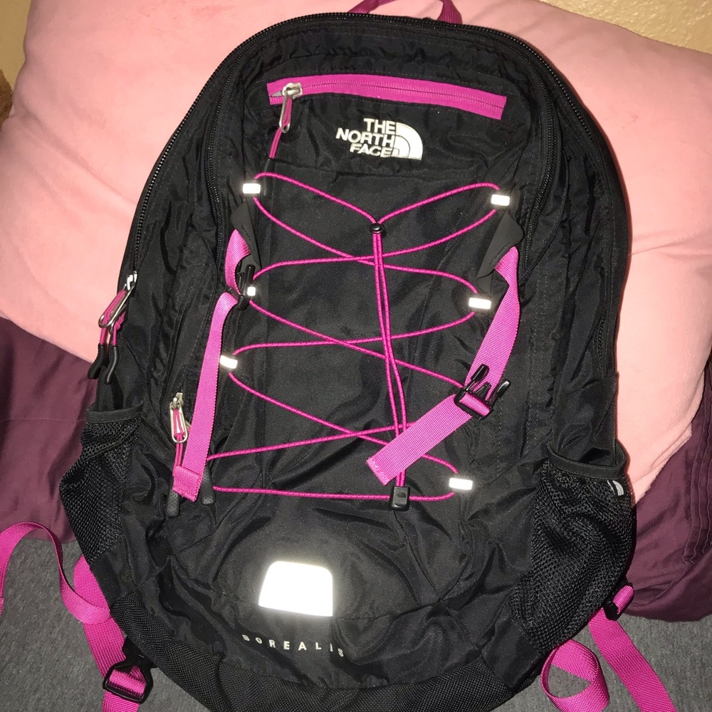 Black and hot pink north face backpack